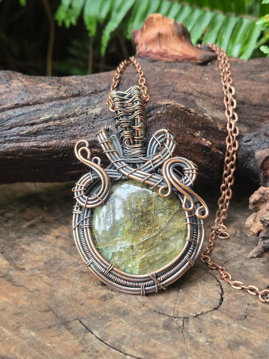 Copper Necklace with a labradorite stone on a wooden surface