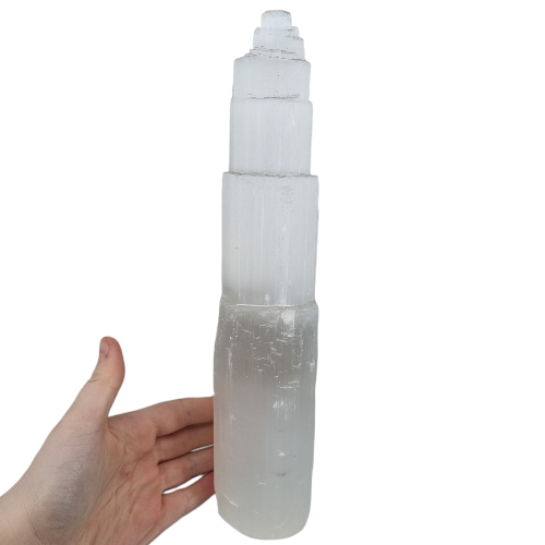 Large selenite crystal tower with a white background
