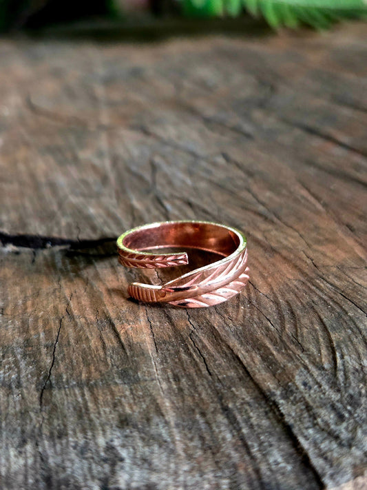 Copper ring on a wooden surface with a natural background