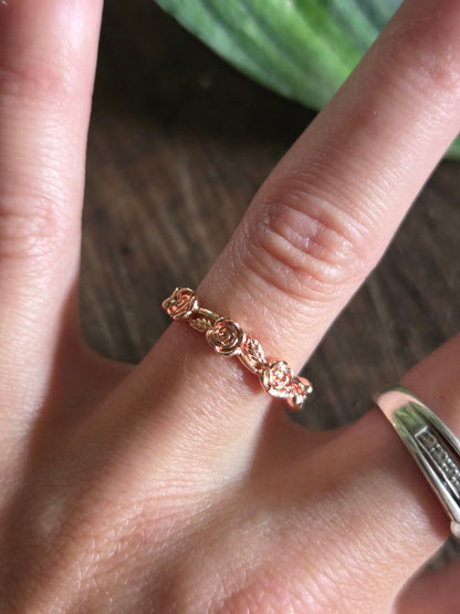 Rose gold ring on a finger with a natural background