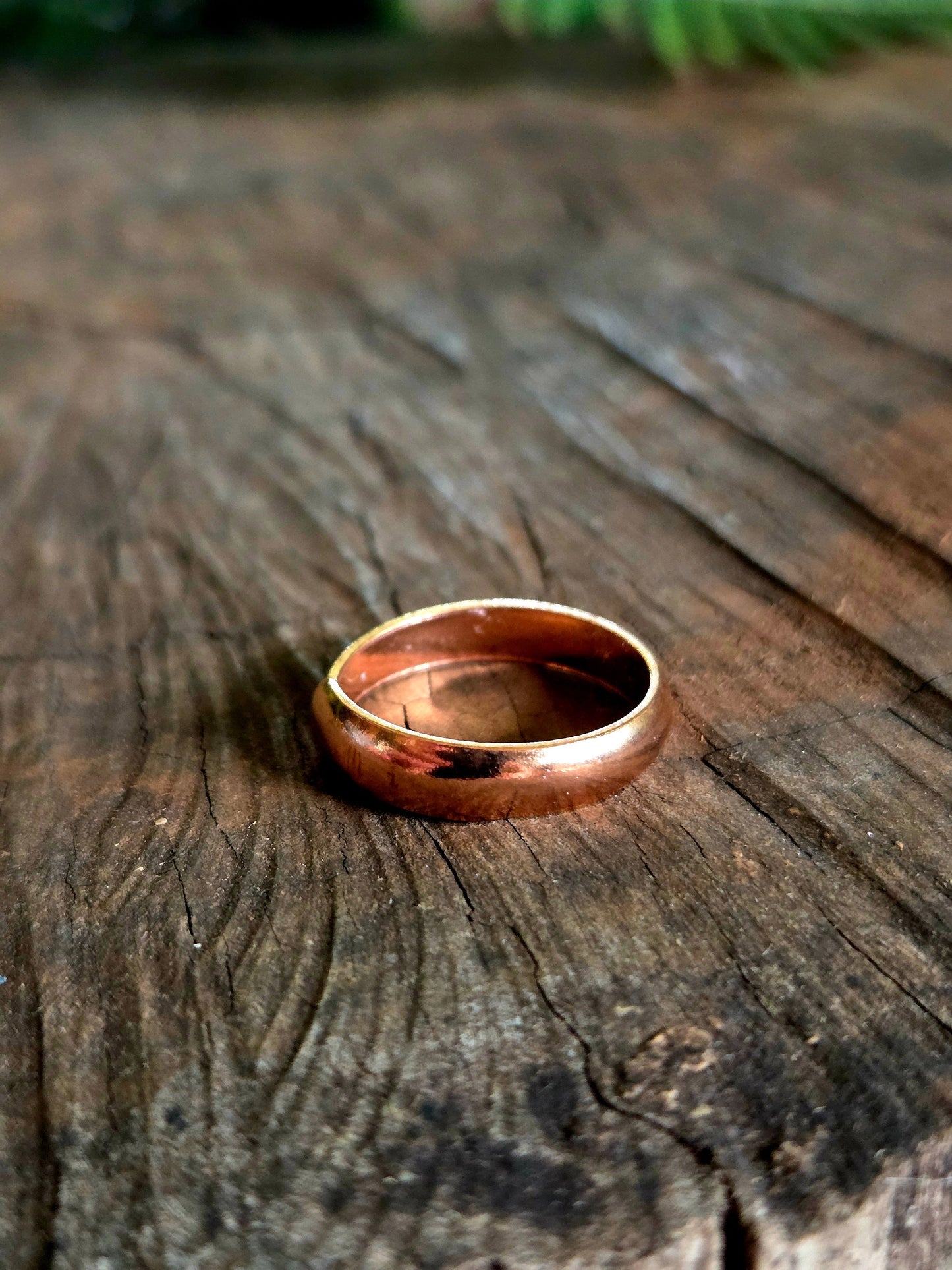 Pure Copper ring on a wooden surface