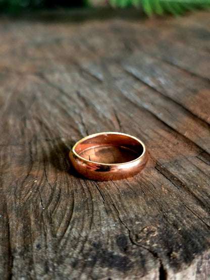Pure Copper ring on a wooden surface
