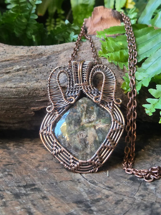 Copper wire-wrapped pendant with a natural background